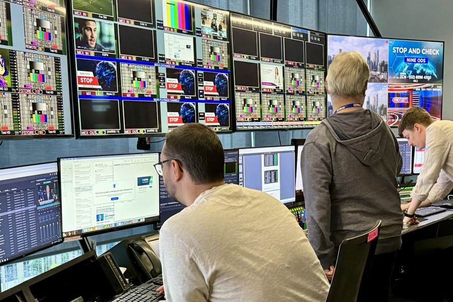 People working in a control room.