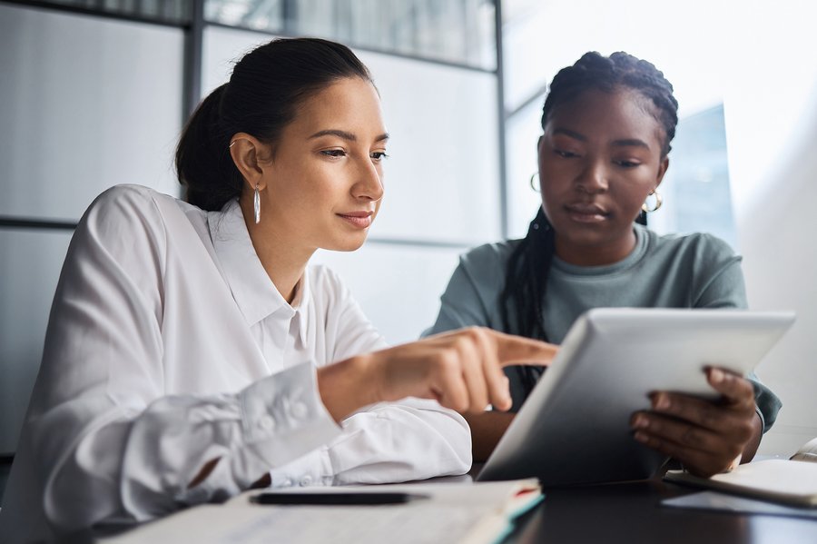 Two women using a tablet together.