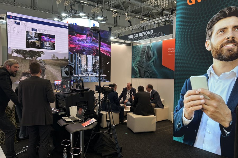 People networking at the Qvest booth at PMRExpo.