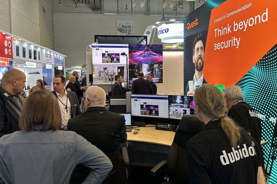 Visitors engaged at the Qvest booth at PMRExpo.