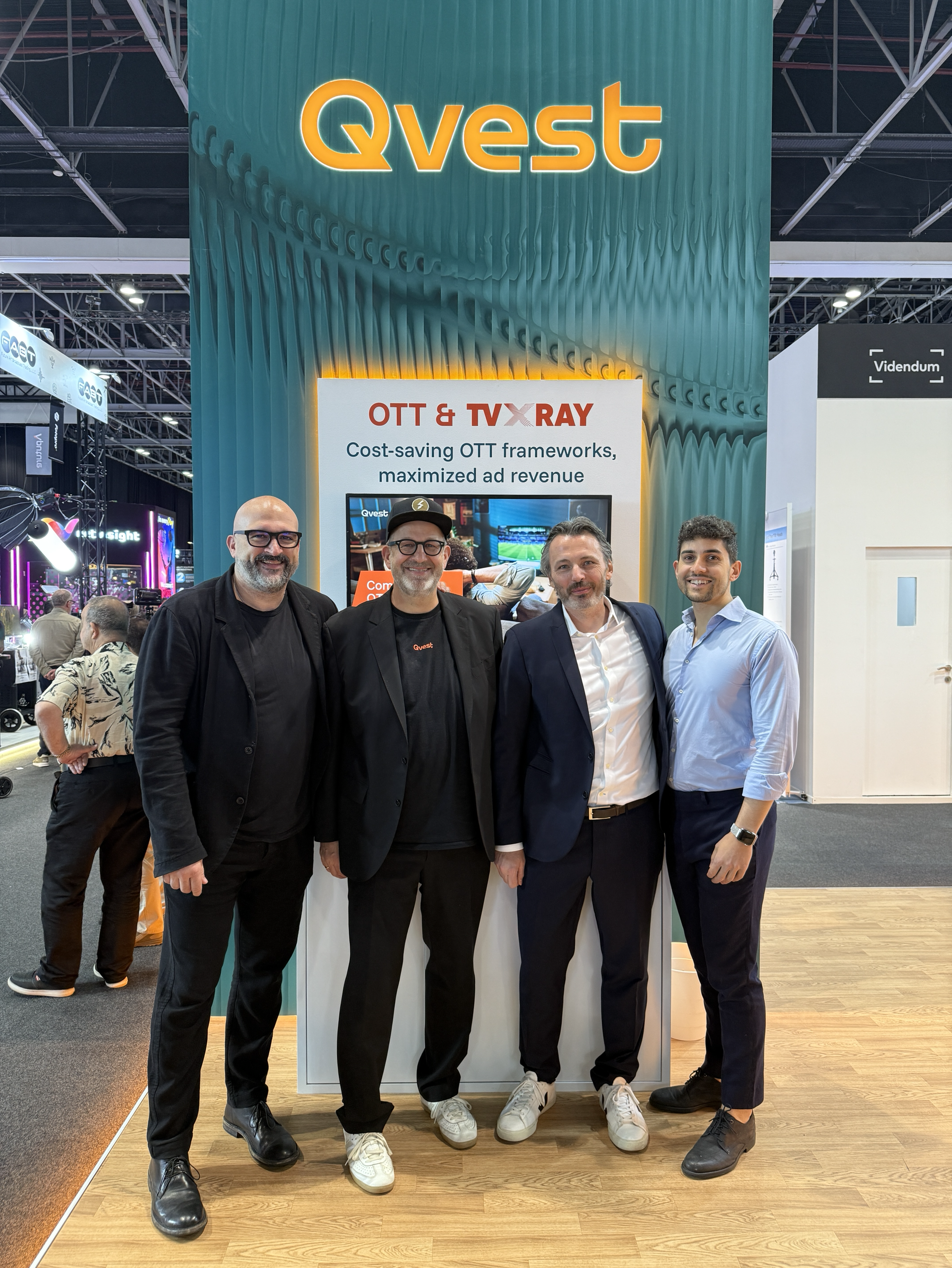 Group of four men at an event booth.