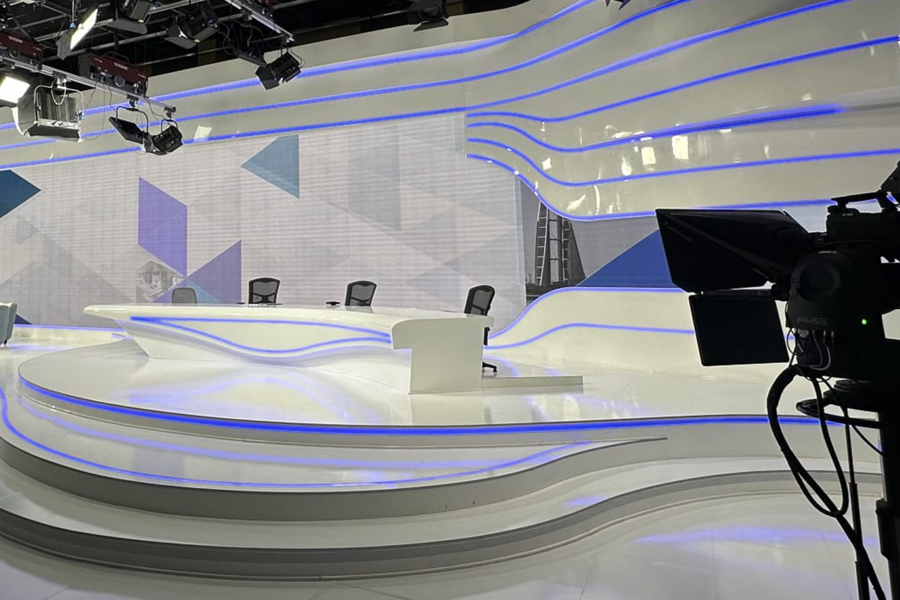 Modern TV studio with cameras and lights.