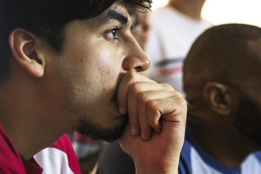 Group of men watching intently.