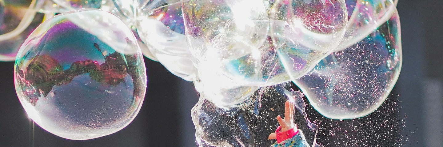 little kid playing with soap bubbles