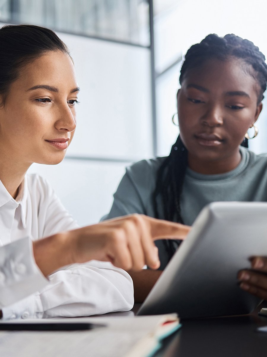 Two women using a tablet together.